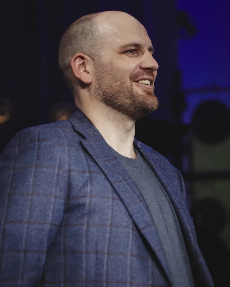 Maxwell Henry smiling, photographed on stage